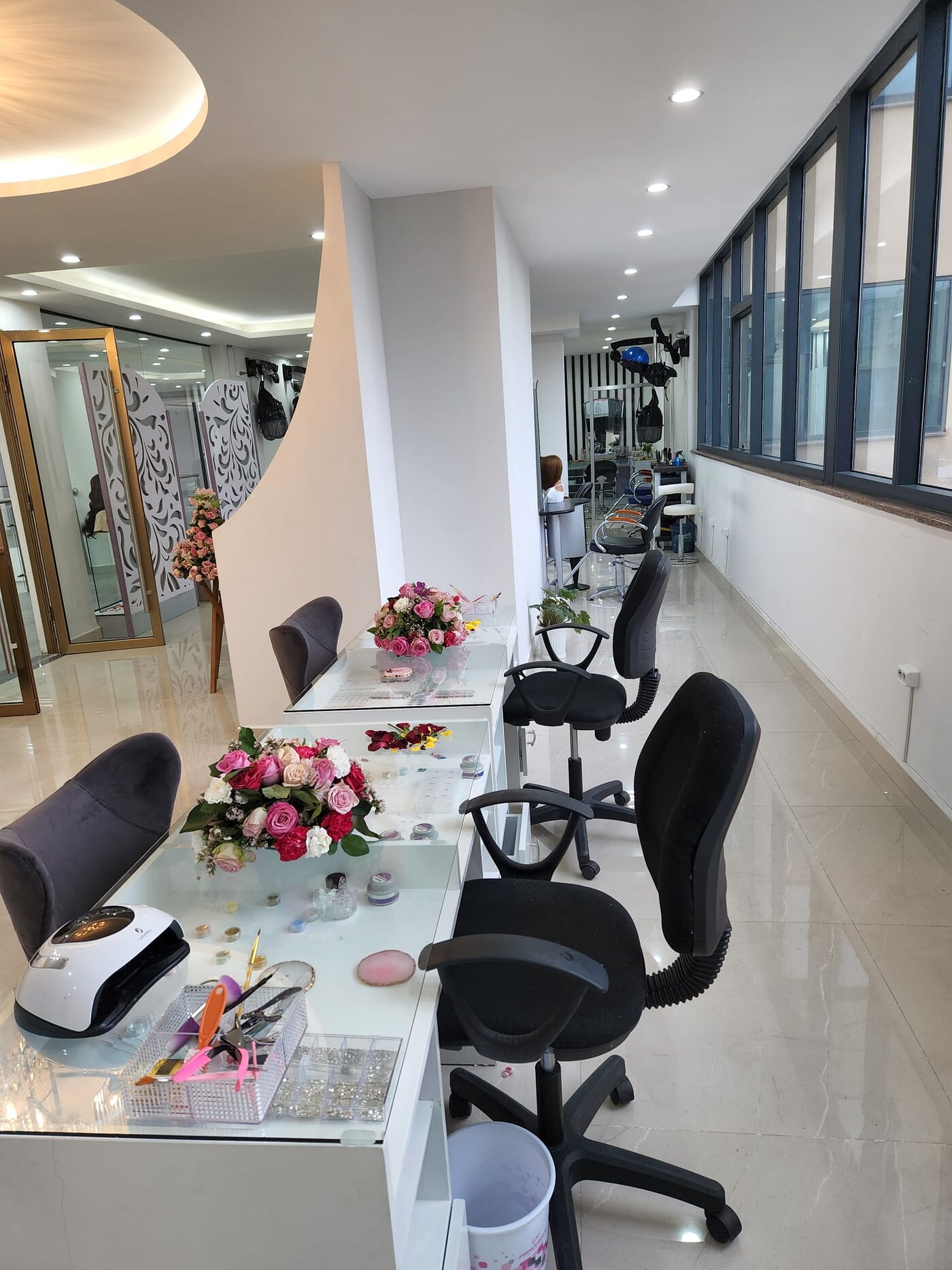 Stylist chairs at Bloom Beauty with flower arrangements